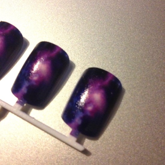 FlashOnGalaxyPrintNailsCloseUp